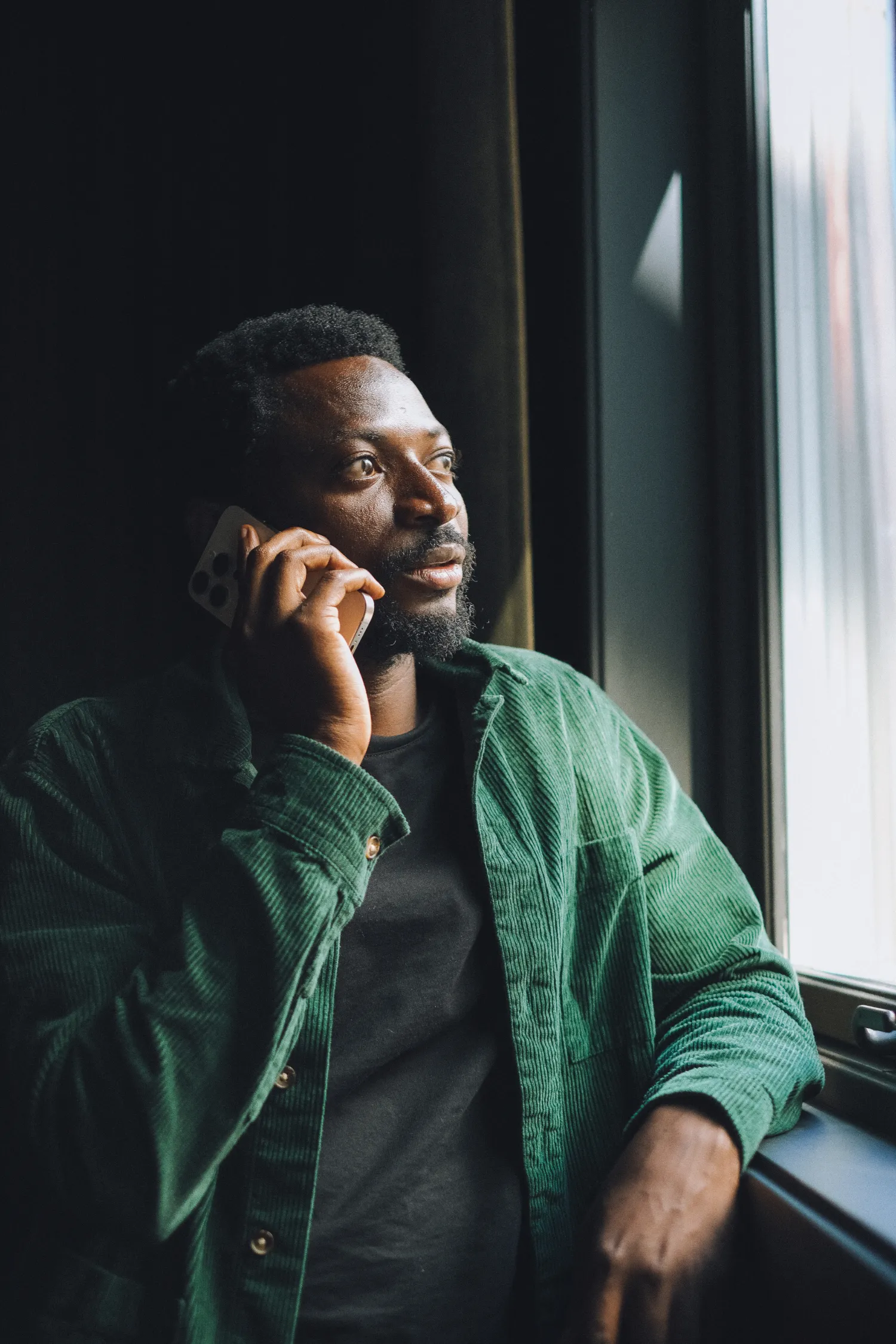 A LemFi customer taking a call by a window